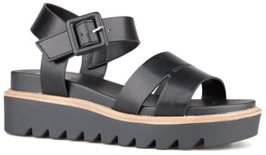 Black platform sandal with buckle ankle strap and lug sole.