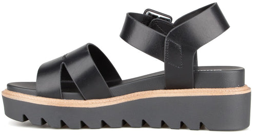Black, lug sole sandal with a buckle and crisscross straps.