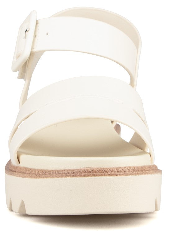 Front view of platform sandal with white straps and buckle.