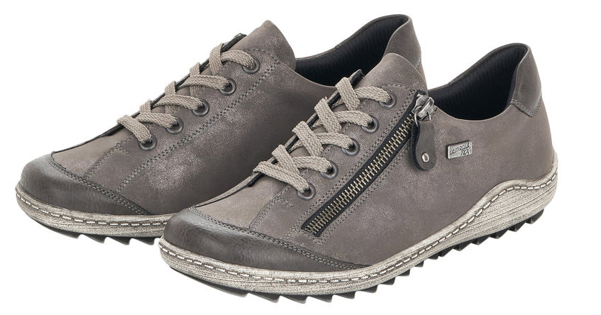Pair of gray lace-up sneakers with side zippers and ridged soles.