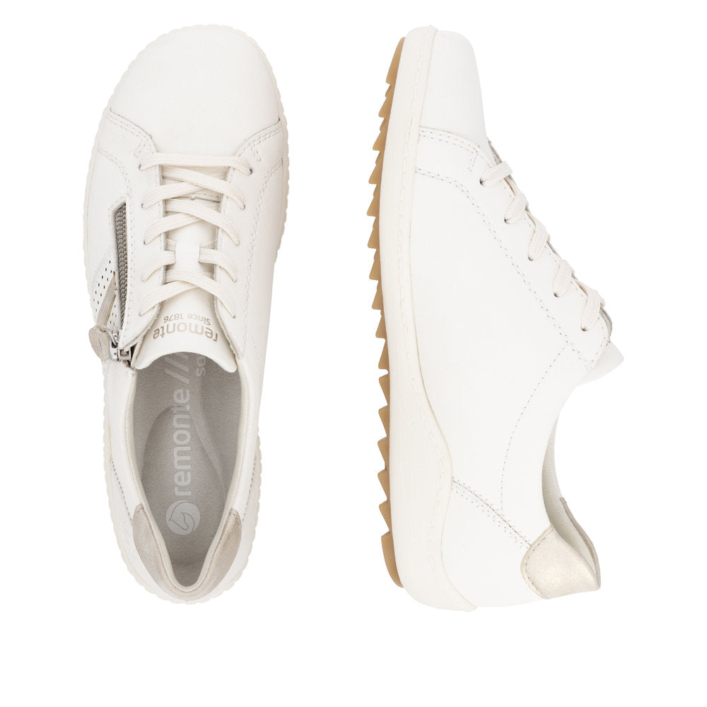 Two women's white leather sneakers, one top down, one side view, laces and zipper detail
