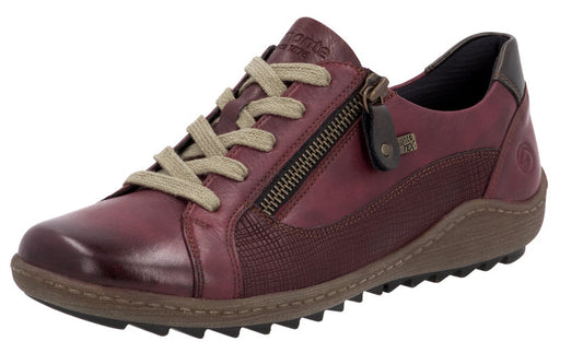 Red leather low-top sneaker with zipper closure and beige laces.