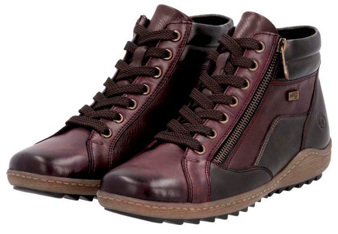 Pair of burgundy leather ankle boots with laces and side zippers.