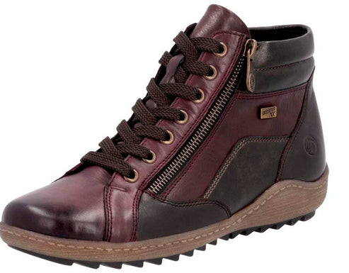 A high-top, lace-up, leather boot with a zipper running the length of the side of the boot.