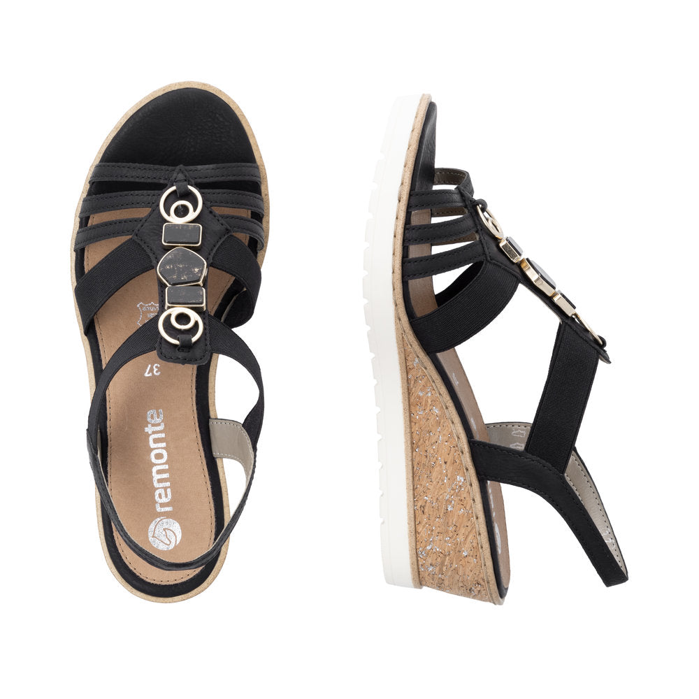 Black wedge sandals with decorative metal details on straps and the word "remonte" printed on the insole.