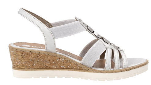 White wedge sandal with elastic straps and decorative metal accents.