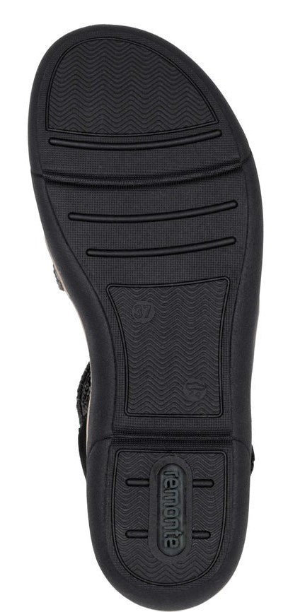 Black sandal sole with a wavy pattern.