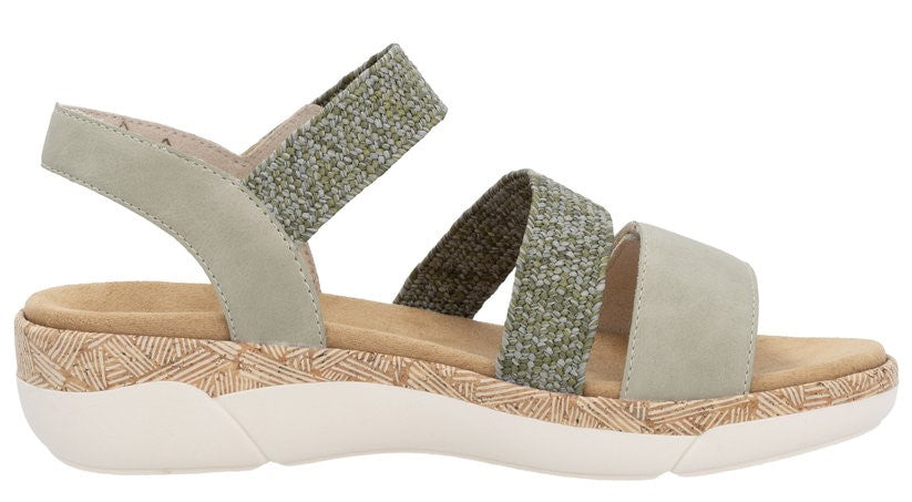 Sandal with green elastic and suede straps, cork footbed, and white sole.