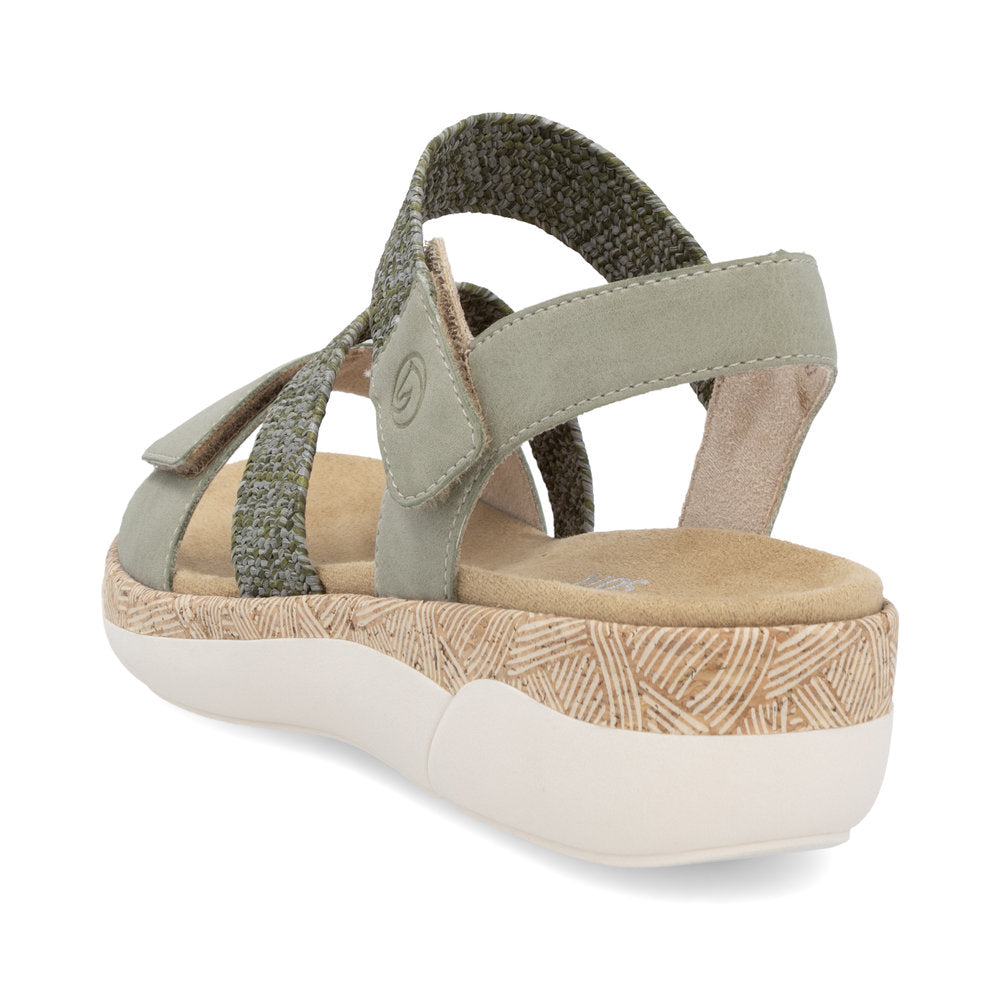 Green sandal featuring adjustable hook-and-loop straps and a textured midsole.