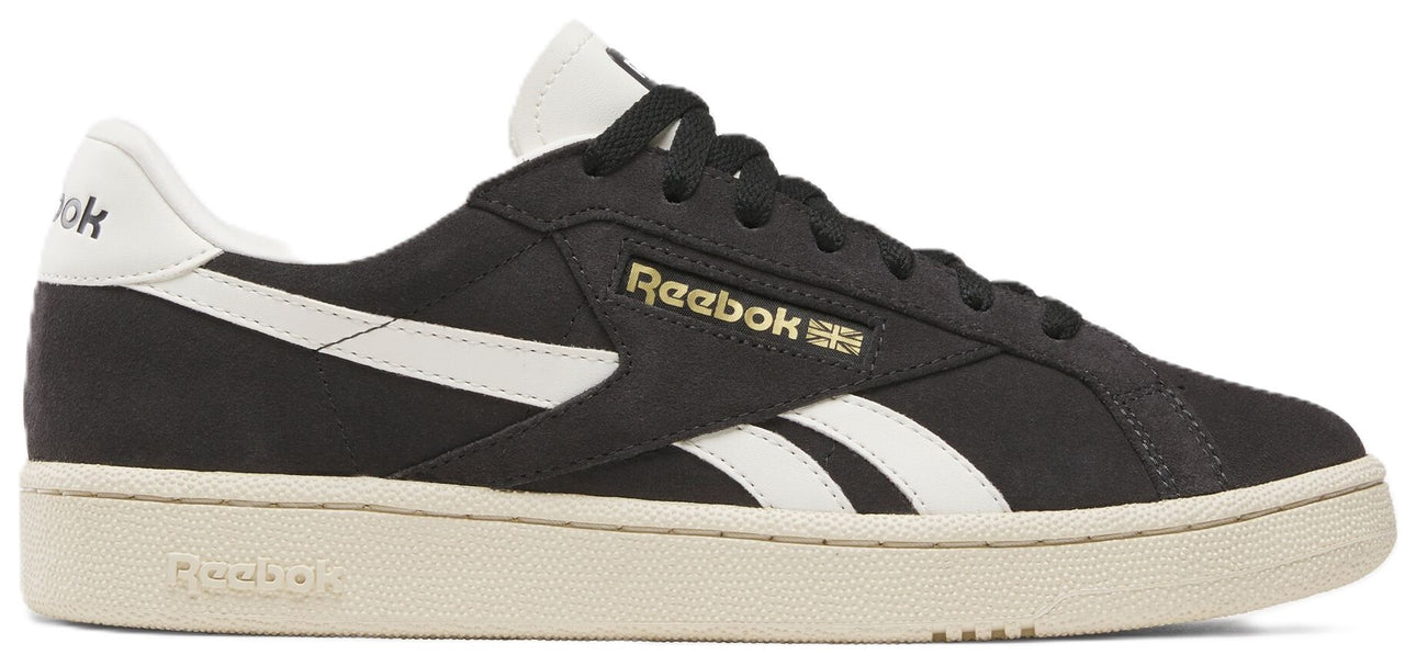 Black athletic shoe with white stripe and off-white sole.