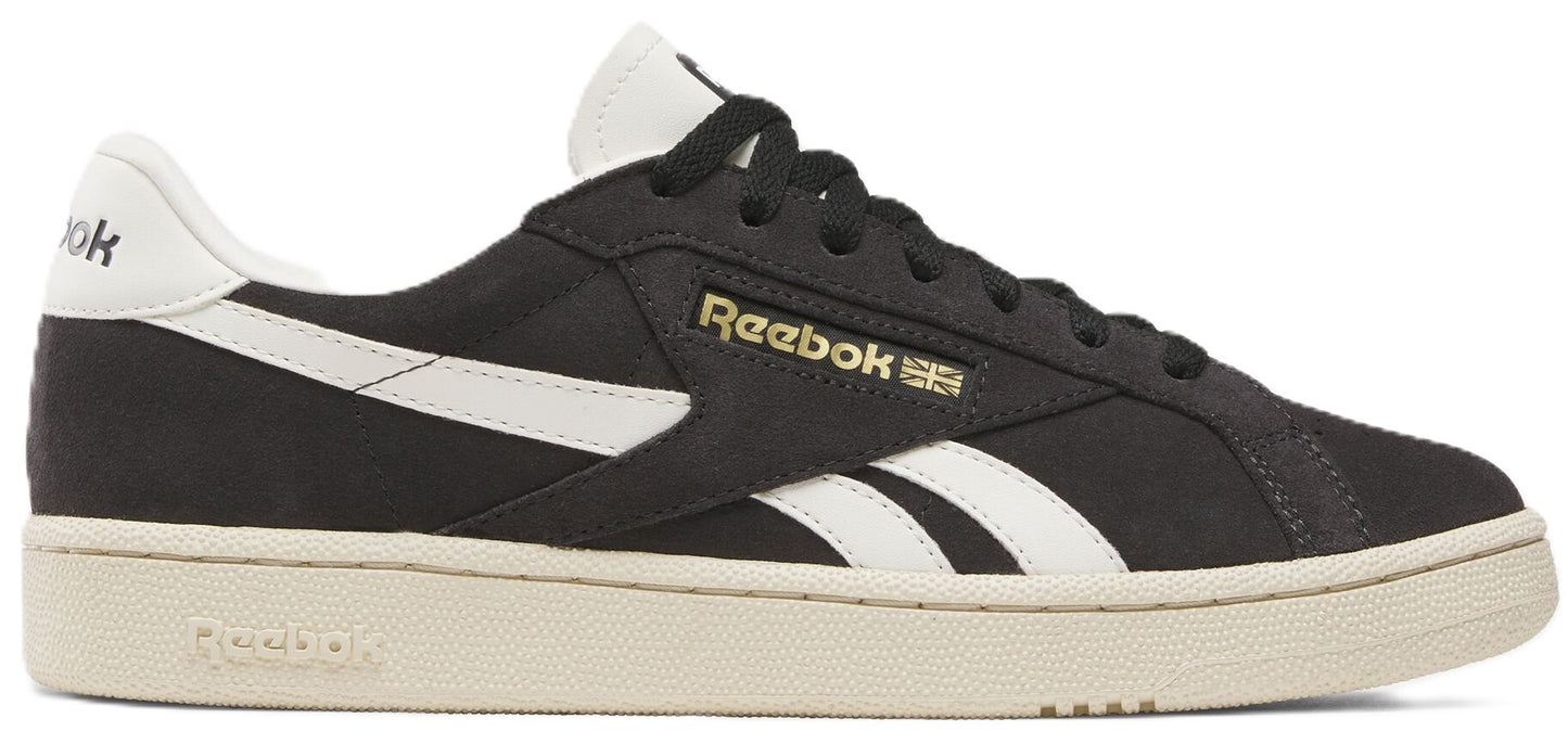 Black athletic shoe with white stripe and off-white sole.