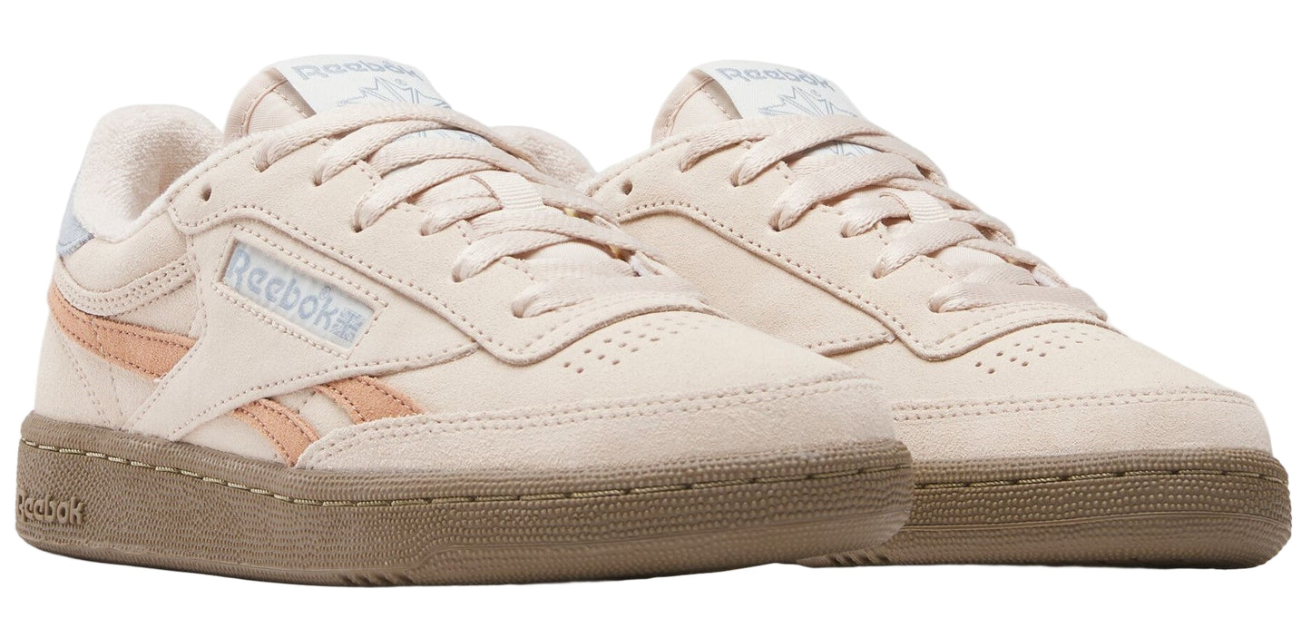 Two tan sneakers with a brown sole, laces, and the word "Reebok" on the side.