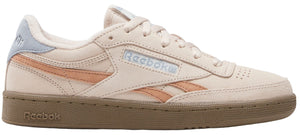 A sneaker with peach accents and a light blue heel accent.