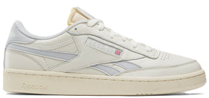 A sneaker in off-white with grey stripes.