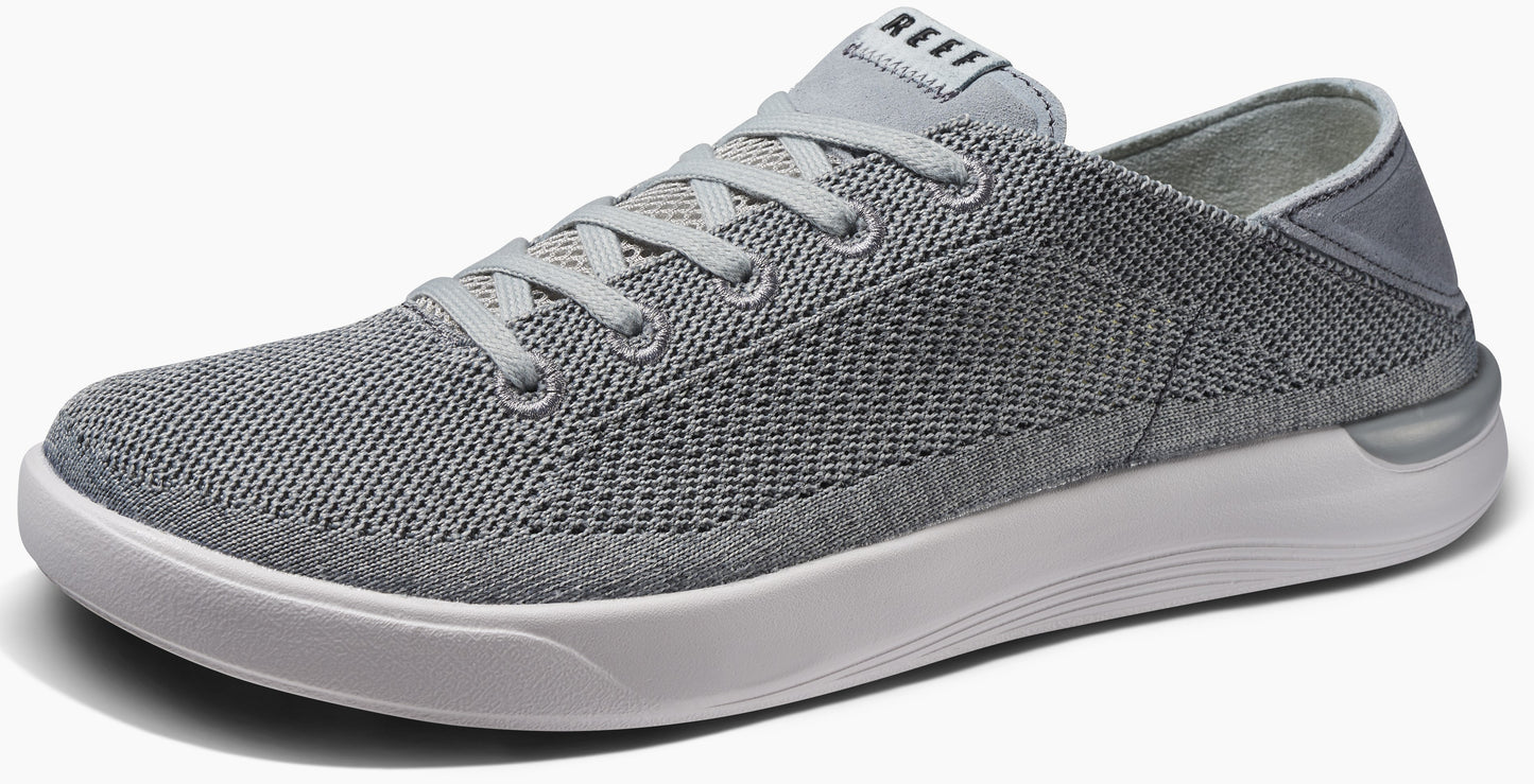 Low profile gray knit sneaker with white sole and lace closure