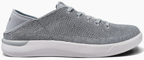 A gray sneaker with white soles and laces.