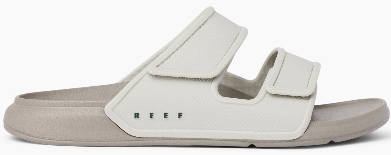 A slide sandal featuring an adjustable strap and the letters R E E F in all caps.