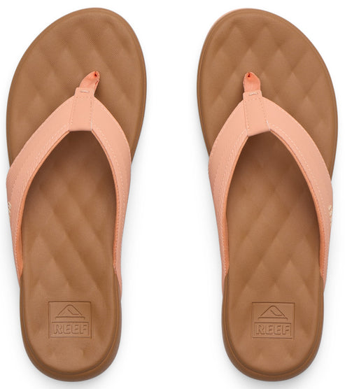 Pair of coral flip-flops with diamond-patterned tan soles and matching coral straps.