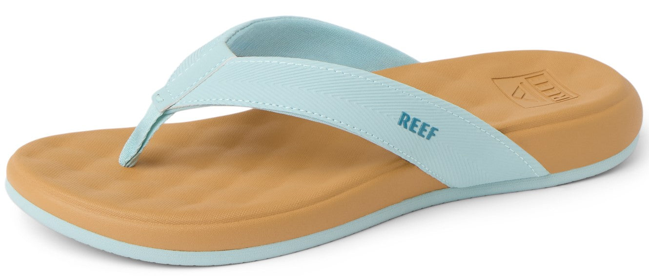 A sandal with light blue straps and a brown sole, displaying the word REEF in blue letters.