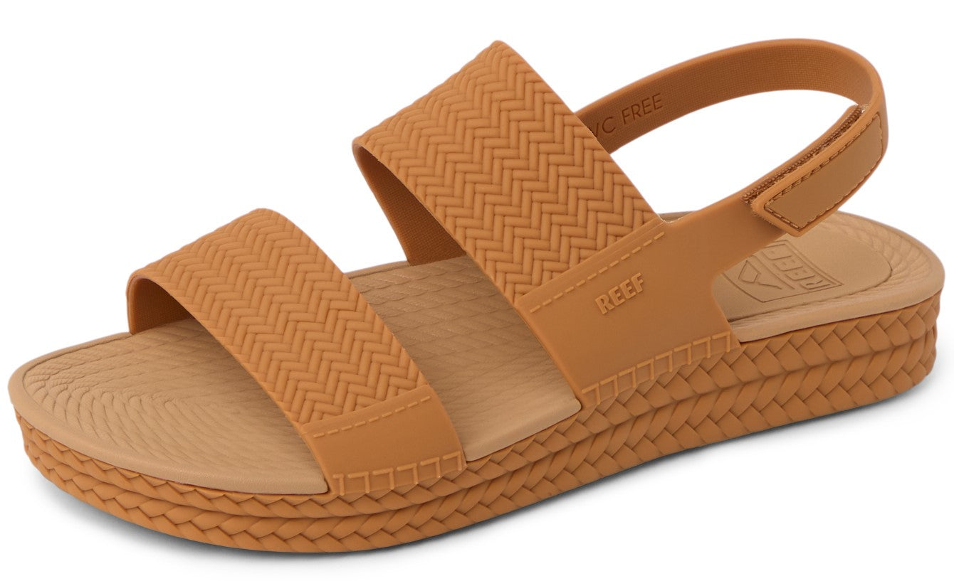 Caramel-colored sandal with two textured horizontal straps and adjustable heel strap.