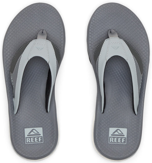 Gray flip-flops with white straps, soles featuring a textured diamond pattern and "REEF" logo.