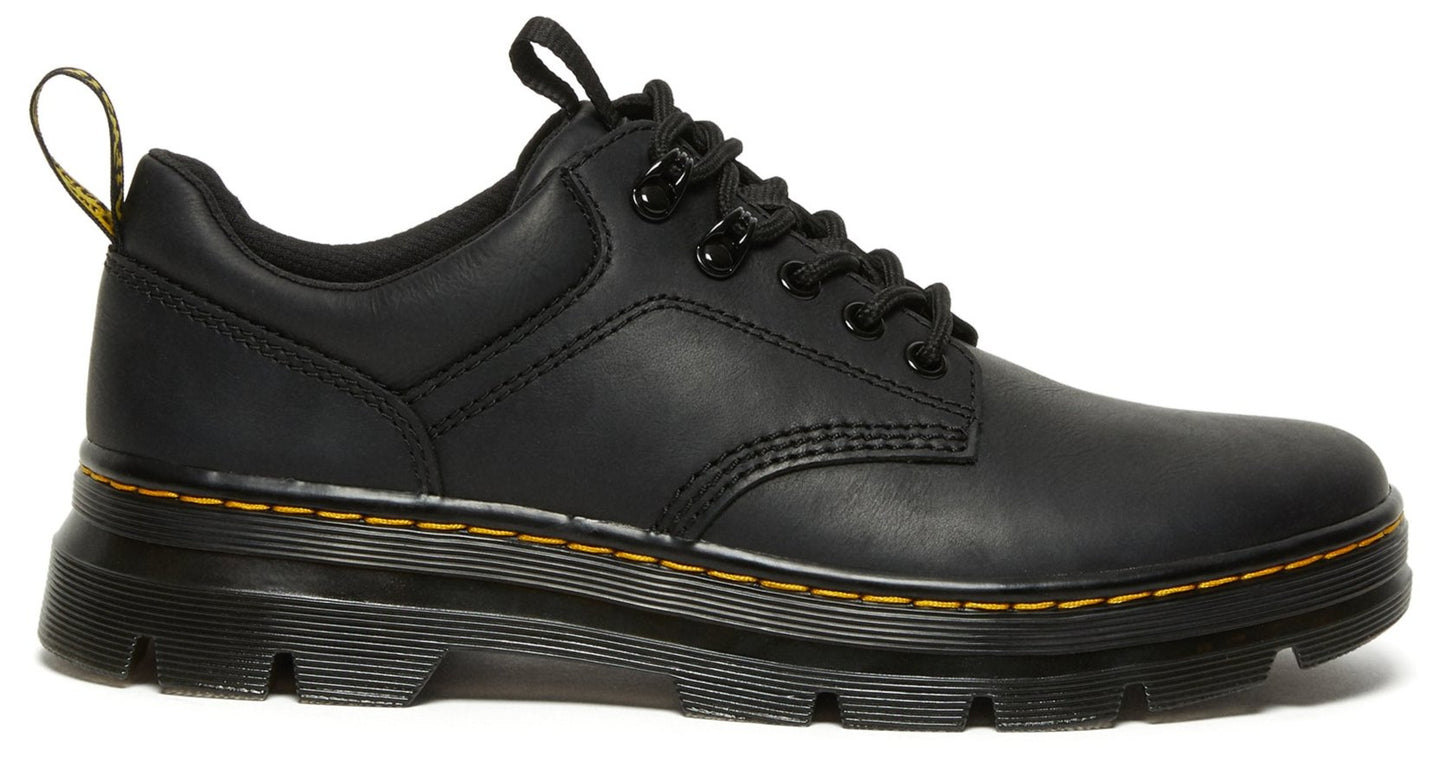 Low-cut, black leather shoe with lug sole and yellow stitching.