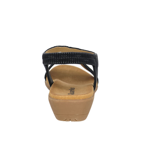A black, elastic sandal with tan insole and heel.