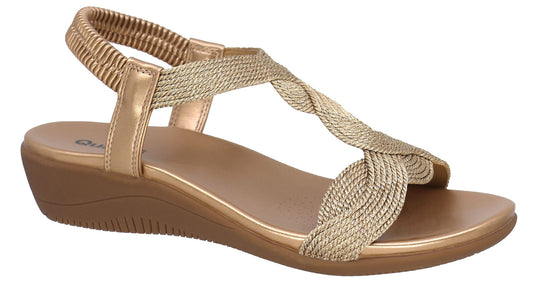 Wedge sandal with gold braided straps and elastic ankle strap.