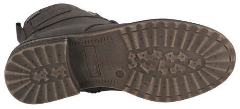 The sole of a brown lug-soled boot.