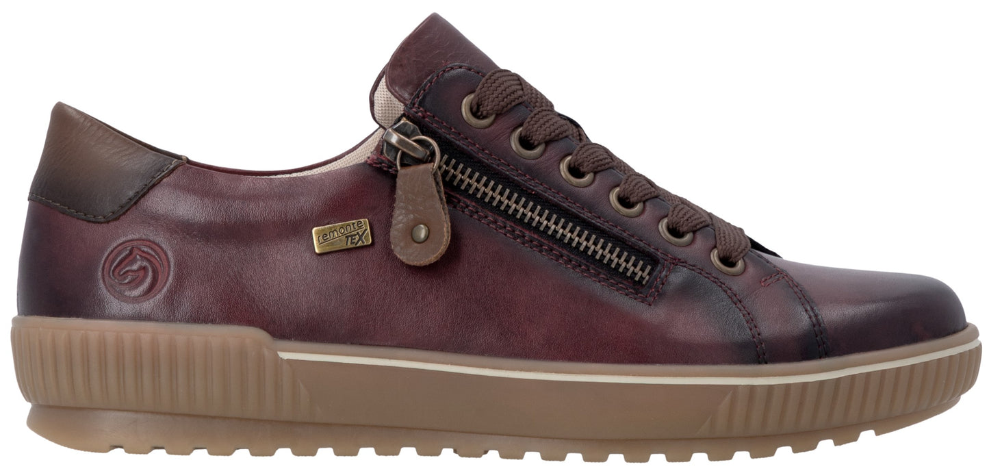 A maroon leather sneaker with a side zipper, brown laces, a brown rubber sole with a textured ribbed sidewall, and a logo embossed on the heel area.