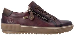 A maroon leather sneaker with a side zipper, brown laces, a brown rubber sole with a textured ribbed sidewall, and a logo embossed on the heel area.