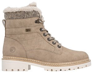 A beige synthetic leather ankle boot featuring a faux-fur lined collar, a side logo detail, lace-up closure with speckled laces, and a thick, white lug sole.