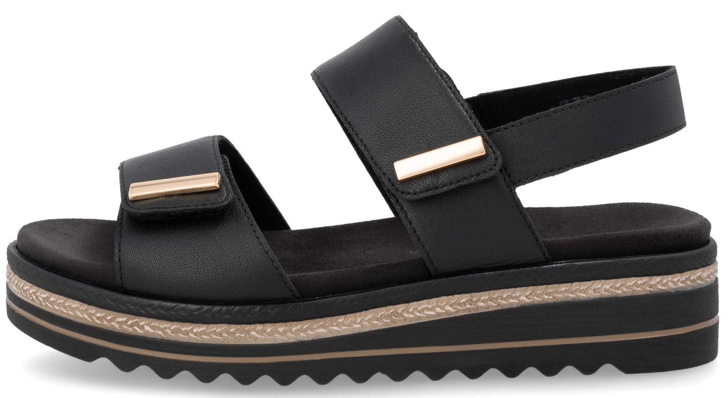 Black platform sandal with two adjustable velcro straps and gold hardware.