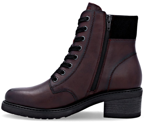 A maroon, leather ankle boot with a lace-up front, a side zipper closure, a black textile cuff at the top, and a sturdy, low-stacked heel with a lugged sole.