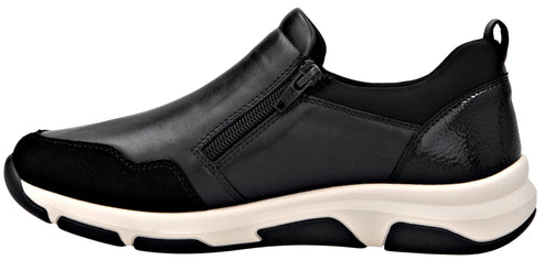 A black leather slip-on shoe with a zipper detail and a white sole.