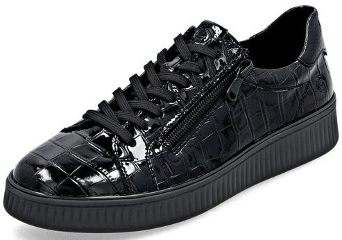 A black, low-top sneaker featuring a glossy, faux-croc skin texture, black laces, a side zipper detail, and a thick, textured black rubber platform sole.