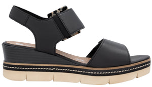 Black wedge sandal with velcro straps and a tan sole.