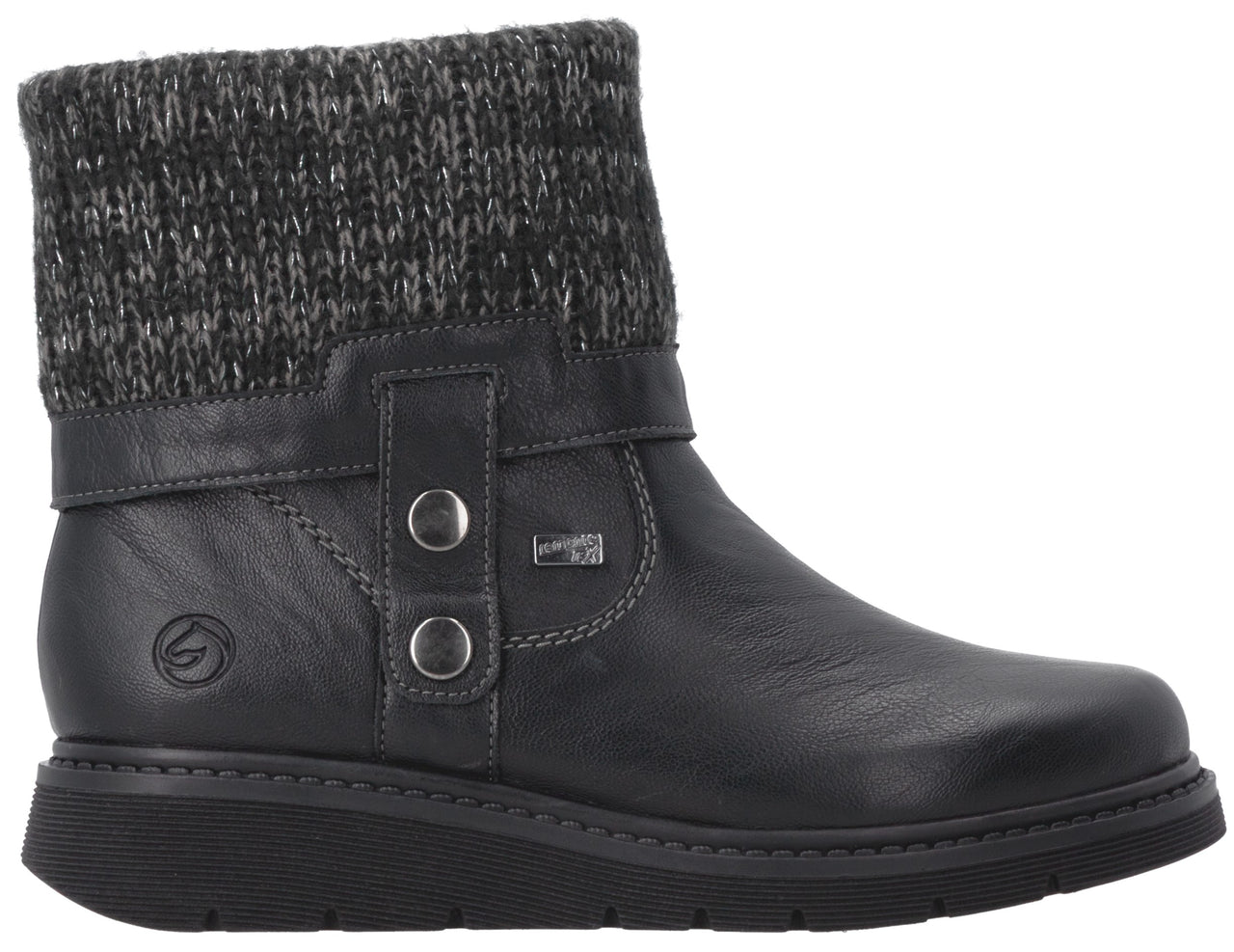 A black leather ankle boot with a grey knit cuff, a side strap with two silver buttons, and a thick black rubber sole.