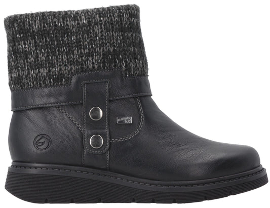 A black leather ankle boot with a grey knit cuff, a side strap with two silver buttons, and a thick black rubber sole.