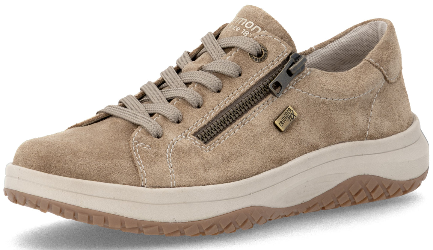 A beige suede sneaker with matching laces, a side zipper, a light-colored chunky sole, and a visible zipper branding tag.
