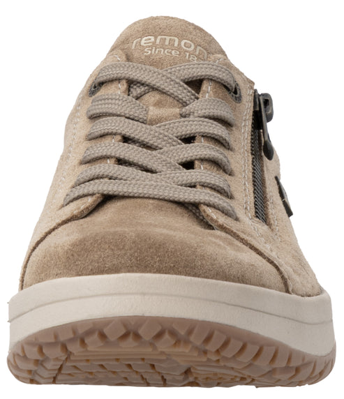 Front view of a beige suede sneaker with matching laces, a side zipper, and a light-colored textured rubber sole, with "remonte" text visible on the tongue.