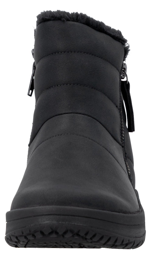 A black ankle-height puffer boot with a matte finish, horizontal stitched detailing on the upper, side zippers, and a warm faux-fur lining along the top edge.