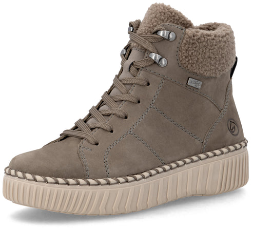A tan, ankle-high lace-up sneaker with a brown faux-fur collar, featuring a thick, ribbed, cream-colored rubber sole with decorative stitching along the top edge, and a small logo embossed on the outer heel.