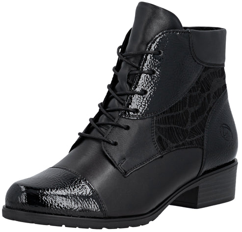 A black ankle boot with a rounded, patent-leather toe cap and a lace-up front. The boot features a textured, patterned side panel, a short block heel, and a small logo embossed on the outer heel area.