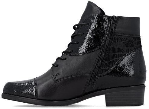 A black ankle boot with a low block heel, lace-up front, and a side zipper, featuring a mix of matte leather and glossy, textured patent leather panels with a subtle abstract pattern on the quarter.