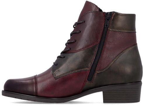 A two-toned, ankle-high leather boot featuring a burgundy front and toe cap with a dark charcoal-colored heel and side panel, designed with a lace-up front, a side zipper, and a low, stacked heel.