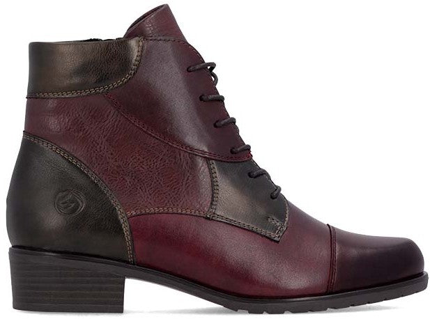 A women's ankle boot in a two-tone burgundy and dark brown color scheme, featuring a lace-up front, a rounded toe, visible stitching details, and a low block heel.