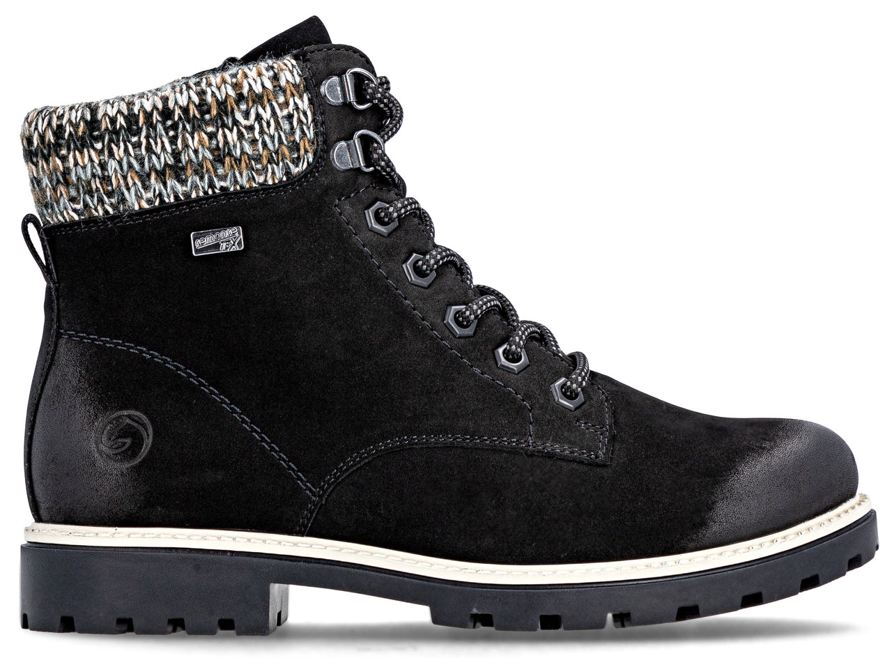 Black ankle-high boot with a white sole and multicolored knit lining.