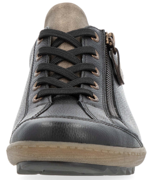 Front view of a black leather sneaker with black laces, bronze-colored eyelets, a side zipper, and a light brown rubber sole.