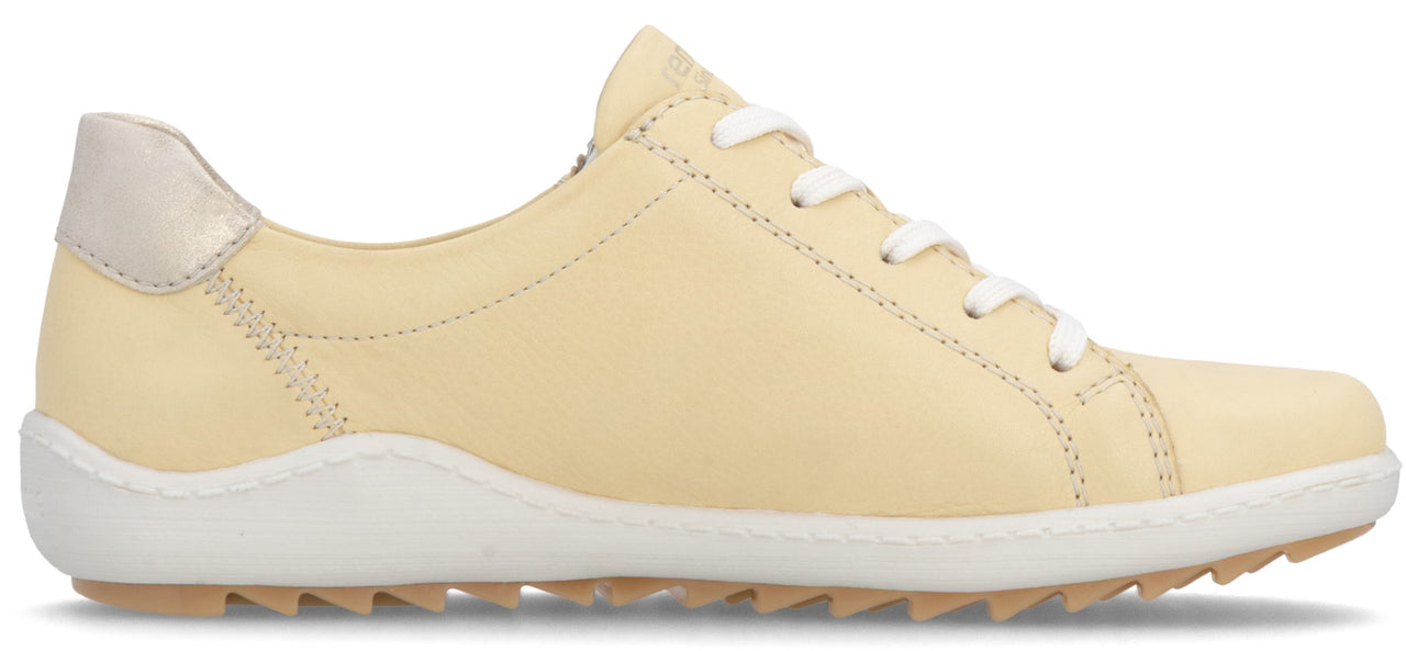 A low top, yellow casual shoe with a white sole and laces.